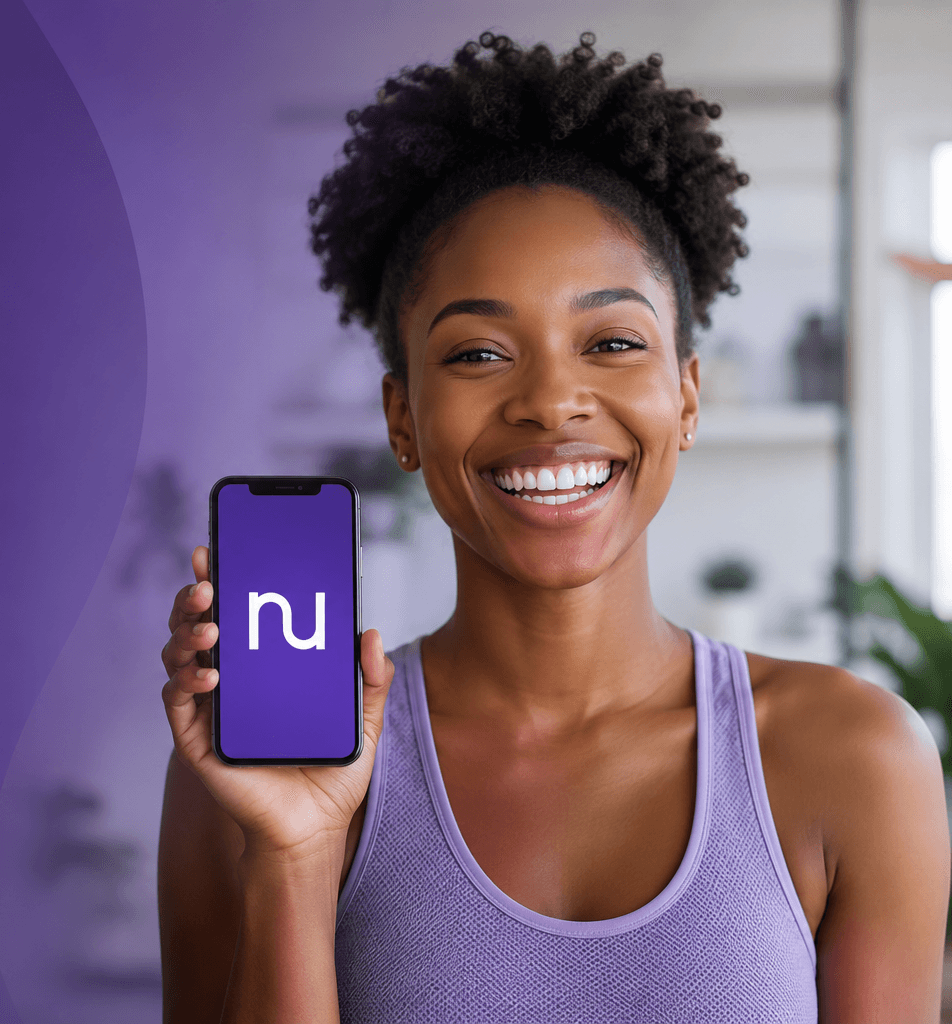 A NuHealth member holding a phone with the nu app