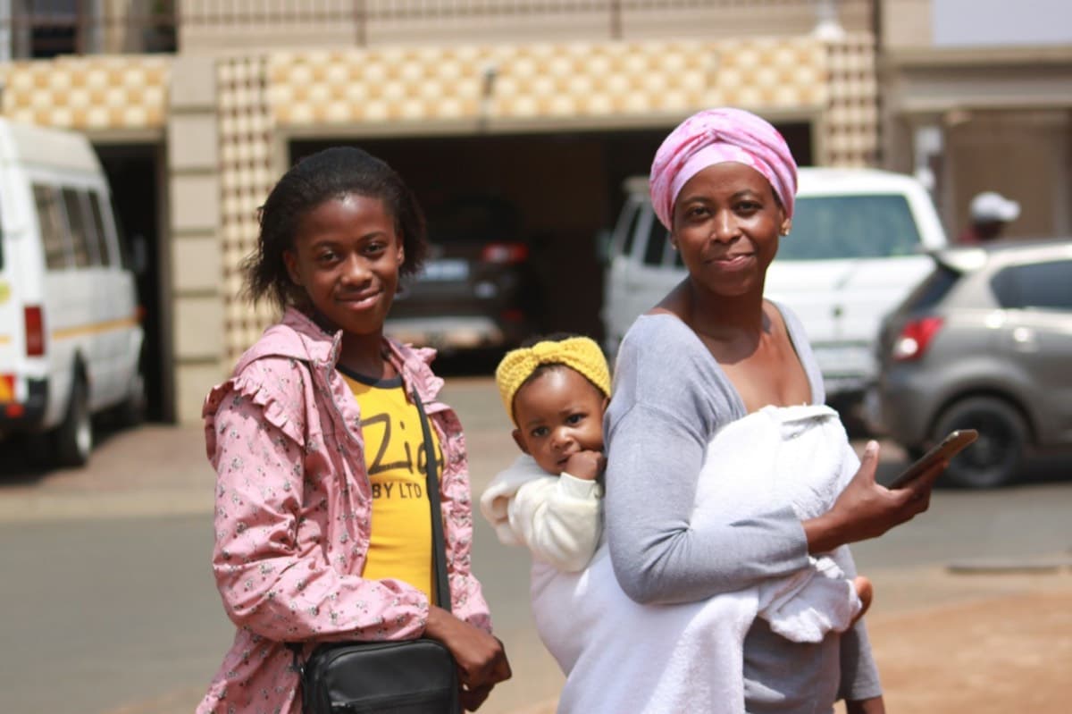 Two mothers with a baby on a South African street